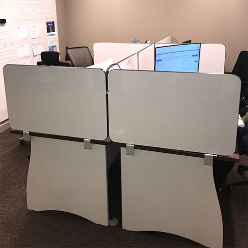 social distancing easy clean laminate desktop partitions attached to the side and back of an office desk